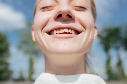 smiling girl with crooked teeth